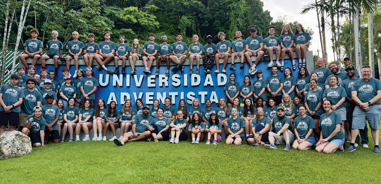 A group of YiELD ministry participants pose in from of a sign in Puerto Rico.
